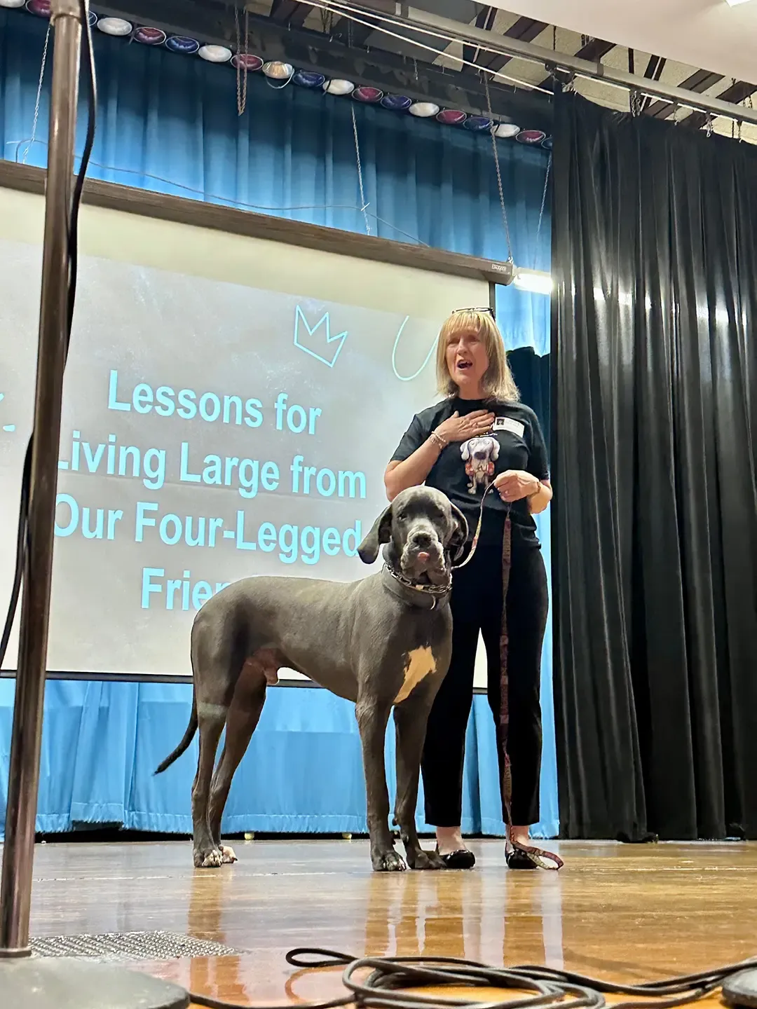 Barb Stone on stage with Great Dane Zeus
